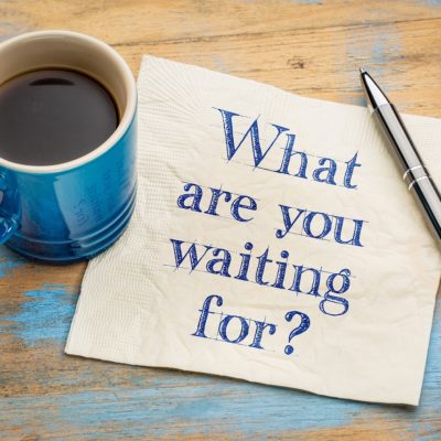 What are you waiting for question - handwriting on a napkin with a cup of espresso coffee